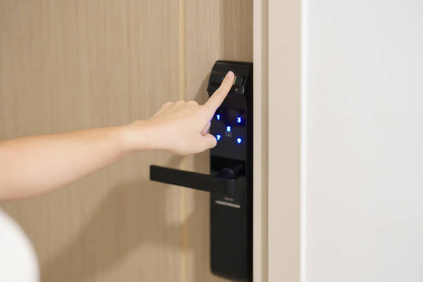 A person using a smart lock with a keypad, highlighting home security advancements.